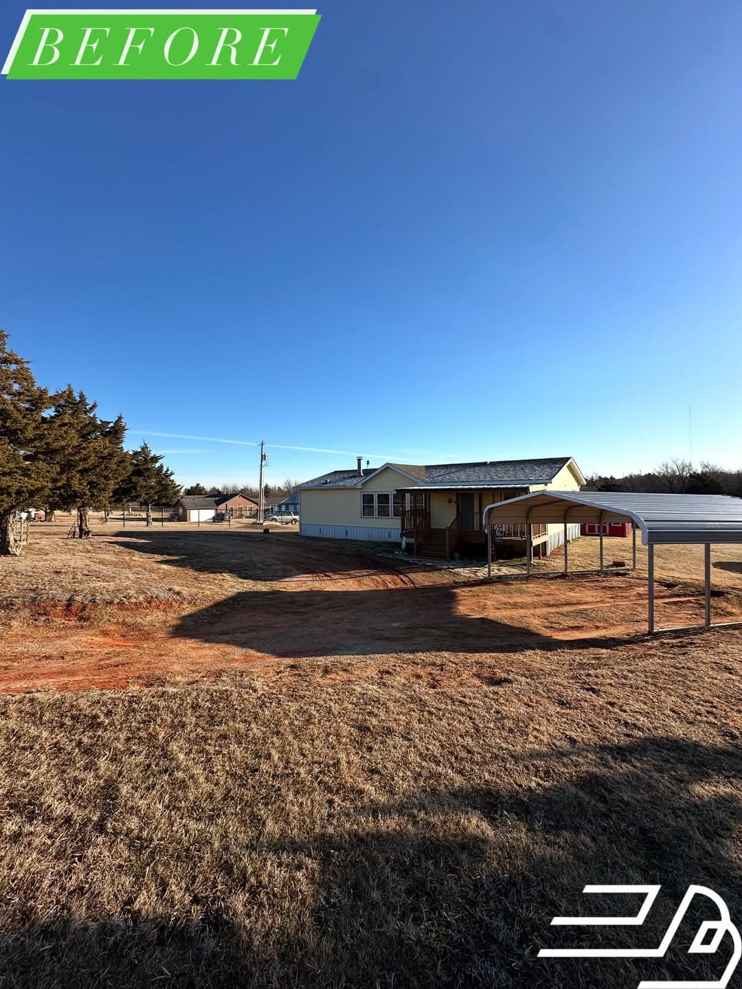 Rural Oklahoma property before gravel was delivered and spread, with rutted bare ground at the carport