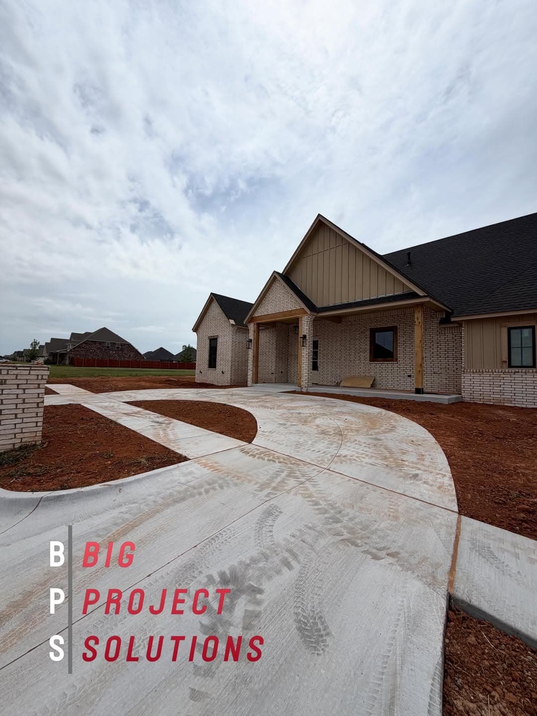 New construction home with a finished concrete drive and freshly graded yard ready for sod in the Oklahoma City metro