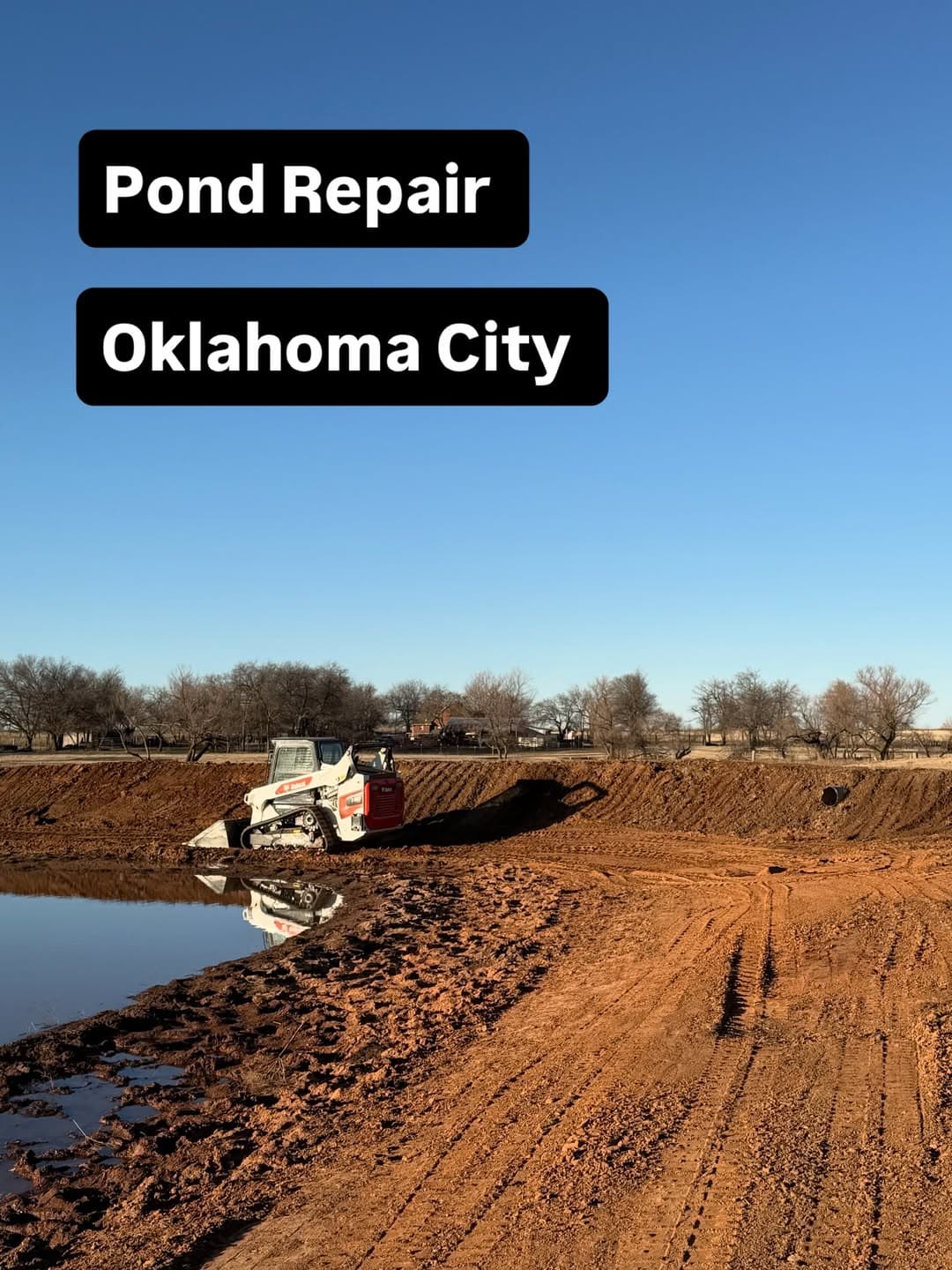 Bobcat track loader reshaping a pond bank during pond repair near Oklahoma City